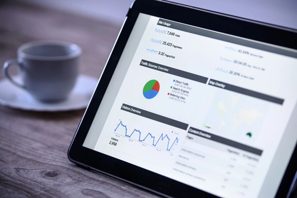 Tablet displaying data analytics with charts and graphs.