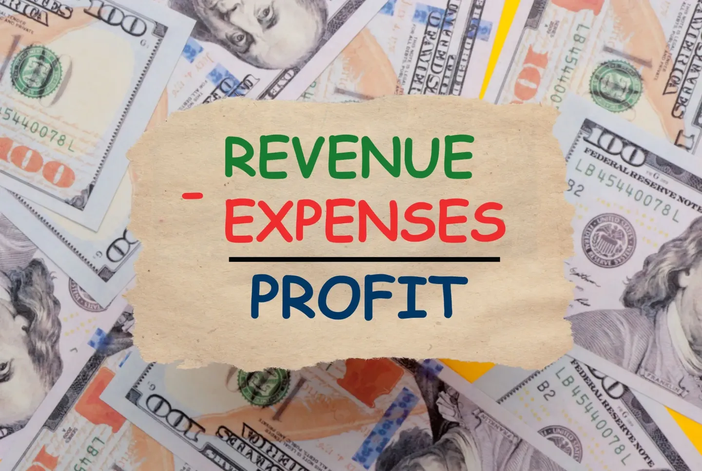 Revenue, expenses, and profit handwritten on a torn paper.