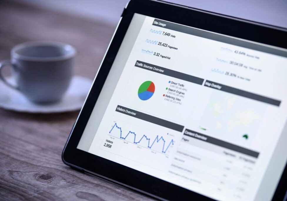 Tablet displaying data analytics with charts and graphs.